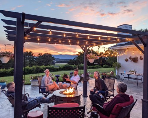 a-family-relaxing-around-a-fire-table-in-outdoor-s-2025-03-11-18-30-57-utc a-family-relaxing-around-a-fire-table-in-outdoor-s-2025-03-11-18-30-57-utc