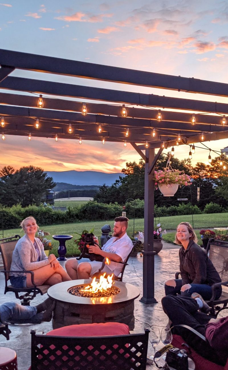 a-family-relaxing-around-a-fire-table-in-outdoor-s-2025-03-11-18-30-57-utc a-family-relaxing-around-a-fire-table-in-outdoor-s-2025-03-11-18-30-57-utc