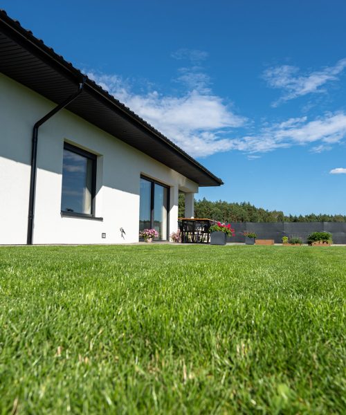 Beautiful garden with green grass, visible terrace table and house in beautiful summer weather, very wide shot. Beautiful garden with green grass, visible terrace table and house in beautiful summer weather, very wide shot.